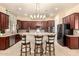 Modern kitchen with granite countertops, stainless steel appliances, and seating at the breakfast bar at 816 W Sycamore Ct, Litchfield Park, AZ 85340