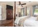 Comfortable main bedroom with hardwood floors, a four-poster bed, and an en-suite bathroom at 816 W Sycamore Ct, Litchfield Park, AZ 85340