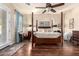 This is a spacious main bedroom with a four-poster bed and ceiling fan, with access to the outside at 816 W Sycamore Ct, Litchfield Park, AZ 85340