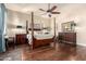 The spacious main bedroom has hardwood floors, a four-poster bed and ample natural light at 816 W Sycamore Ct, Litchfield Park, AZ 85340