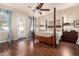 Elegant main bedroom features a four-poster bed, hardwood floors, and natural light, creating a serene retreat at 816 W Sycamore Ct, Litchfield Park, AZ 85340