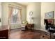 Functional home office space featuring hardwood floors, a desk, and natural light at 816 W Sycamore Ct, Litchfield Park, AZ 85340