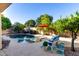 Private backyard oasis showcasing a refreshing pool, patio furniture, and lush greenery for relaxation at 816 W Sycamore Ct, Litchfield Park, AZ 85340