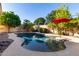 A lovely freeform pool offers luxurious desert living with mature landscaping at 816 W Sycamore Ct, Litchfield Park, AZ 85340