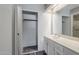 Bathroom vanity with a large closet and a wide mirror reflecting the shower at 818 S Westwood -- # 101, Mesa, AZ 85210
