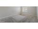 Carpeted bedroom with neutral paint and good light from the large window at 818 S Westwood -- # 101, Mesa, AZ 85210