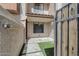 Inviting townhome entry featuring stone pavers, a touch of green turf, and gate access to the cozy front patio at 818 S Westwood -- # 101, Mesa, AZ 85210