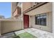 Townhome entry features stone pavers, a touch of green turf, and a charming red front door at 818 S Westwood -- # 101, Mesa, AZ 85210
