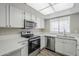 Well-lit kitchen with stainless steel appliances, white cabinets, and light countertops at 818 S Westwood -- # 101, Mesa, AZ 85210