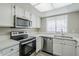 Bright kitchen with stainless steel appliances, white cabinets, and lots of counter space at 818 S Westwood -- # 101, Mesa, AZ 85210