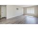 Spacious living room featuring durable wood-look flooring, neutral walls, and a view to the front patio at 818 S Westwood -- # 101, Mesa, AZ 85210