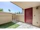 Private patio features artificial turf, tiled flooring, and a striking red entry door at 818 S Westwood -- # 101, Mesa, AZ 85210