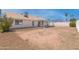 Expansive backyard featuring a covered patio, desert landscaping, and privacy fencing at 962 W Keating Ave, Mesa, AZ 85210