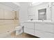 Bright bathroom features a double sink vanity and shower with grab bars at 962 W Keating Ave, Mesa, AZ 85210