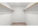 Walk-in closet featuring neutral carpet and wooden closet rods at 962 W Keating Ave, Mesa, AZ 85210