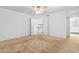 Main bedroom with neutral carpet, ceiling fan, and ensuite bathroom access at 962 W Keating Ave, Mesa, AZ 85210