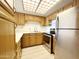 Kitchen with wood cabinets and stainless appliances at 10330 W Thunderbird Blvd # B313, Sun City, AZ 85351