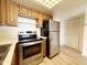 Kitchen with wood cabinets and stainless steel appliances at 10330 W Thunderbird Blvd # B313, Sun City, AZ 85351
