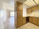 Kitchen with wood cabinets, modern appliances, and new wood floors at 10330 W Thunderbird Blvd # B313, Sun City, AZ 85351