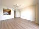 Bright living room featuring wood flooring with kitchen in the background at 10330 W Thunderbird Blvd # B313, Sun City, AZ 85351