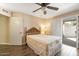A bright bedroom features a wood-look tile floor, ceiling fan, shuttered window, and a closet at 10619 W Loma Blanca Dr, Sun City, AZ 85351