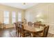 Formal dining room featuring natural light, wood-look tile flooring, and classic decor at 10619 W Loma Blanca Dr, Sun City, AZ 85351