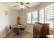 Cozy dining area with a round table, shuttered windows, and a traditional china cabinet at 10619 W Loma Blanca Dr, Sun City, AZ 85351