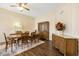 Elegant dining room with decorative molding, chandelier, and wood-look tile flooring at 10619 W Loma Blanca Dr, Sun City, AZ 85351
