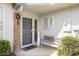 Cozy front entry featuring a decorative security door, bench, and exterior lighting at 10619 W Loma Blanca Dr, Sun City, AZ 85351