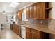 Well-appointed kitchen with granite counters, stainless sink, wood cabinets, and plentiful storage at 10619 W Loma Blanca Dr, Sun City, AZ 85351