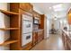 Spacious kitchen featuring custom wood cabinets, granite countertops, and modern appliances at 10619 W Loma Blanca Dr, Sun City, AZ 85351