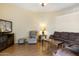 Spacious living room featuring plush seating, wood-look floors, a ceiling fan, and a cozy recliner at 10619 W Loma Blanca Dr, Sun City, AZ 85351