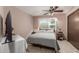 Bedroom featuring a bed, ceiling fan, and a window at 10860 W Buccaneer Dr, Sun City, AZ 85351
