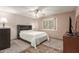 Comfortable bedroom with neutral tones, ceiling fan, and cozy rug at 10860 W Buccaneer Dr, Sun City, AZ 85351