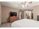 Bedroom featuring a large TV, dresser, and doorway leading to other rooms at 10860 W Buccaneer Dr, Sun City, AZ 85351