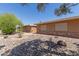 Tan home exterior features desert landscaping, rock ground cover, and brick accents at 10860 W Buccaneer Dr, Sun City, AZ 85351