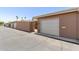 View of multiple garages and entrance gate to property at 10860 W Buccaneer Dr, Sun City, AZ 85351