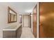 Hallway with a dresser, mirror, and doors at 10860 W Buccaneer Dr, Sun City, AZ 85351
