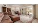 Cozy living area featuring sliding glass doors with backyard access and leather furniture at 10860 W Buccaneer Dr, Sun City, AZ 85351