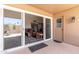 Covered patio with a view of the living room through sliding glass doors at 10860 W Buccaneer Dr, Sun City, AZ 85351