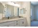 Bathroom featuring granite counters, modern fixtures, and large mirrors at 11002 N 164Th Dr, Surprise, AZ 85388