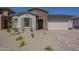 Charming single-story home with stone accents and desert landscaping at 11002 N 164Th Dr, Surprise, AZ 85388