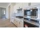 Close-up of kitchen with stainless steel appliances, granite countertops, and white cabinetry at 11002 N 164Th Dr, Surprise, AZ 85388