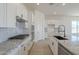 Bright, modern kitchen with white cabinets, granite countertops, and stainless steel appliances at 11002 N 164Th Dr, Surprise, AZ 85388