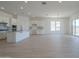 Spacious open floor plan with kitchen island, ample counter space, and light-filled living area at 11002 N 164Th Dr, Surprise, AZ 85388