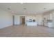 Open-concept living room and kitchen featuring modern white cabinets and light wood floors at 11002 N 164Th Dr, Surprise, AZ 85388