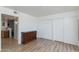 Bright bedroom with wood floors, white walls, closet, and a dark wood dresser at 12123 W Bell Rd # 219, Surprise, AZ 85378
