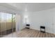 Bedroom with wood-look floors features sliding glass door with balcony access and neutral decor at 12123 W Bell Rd # 219, Surprise, AZ 85378