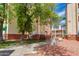 Well-maintained building exterior with mature trees and landscaping around the property at 12123 W Bell Rd # 219, Surprise, AZ 85378