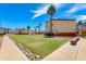 An amazing lawn and landscaping are viewed from a side angle of the condo buildings at 12123 W Bell Rd # 219, Surprise, AZ 85378